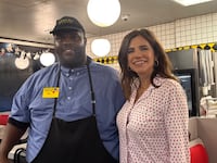 Nancy Mace poses in a Waffle House diner with a member of staff.