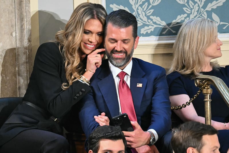 Donald Trump Jr. (R) sits with Bettina Anderson ahead of US President Donald Trump's address to a joint session of Congress in the House Chamber of the US Capitol in Washington, DC, on March 4, 2025.