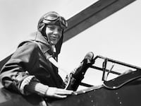 Pennsylvania-Amelia Earhart in the cockpit of her autogiro after setting a new altitude record for women in planes of this type.