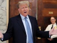 Former U.S. President Donald Trump speaks in the hall way as he attends his Manhattan courthouse trial in a civil fraud case in New York, U.S.