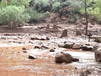 Remnants of stone bridge pylons remain along Bright Angel Creek following a flash flood that destroyed the footbridge on August 29. The flooding caused significant damage to infrastructure throughout the canyon.