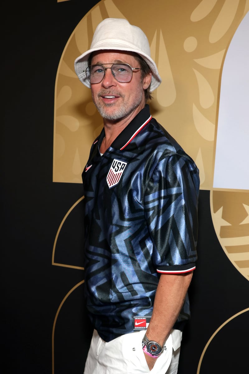 Brad Pitt attends the FIFA World Cup 2026 Group D match between Türkiye and the USA wearing a white bucket hat and aviator glasses in 2026.