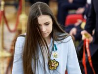 Kamila Valieva walks during a meeting with Vladimir Putin.