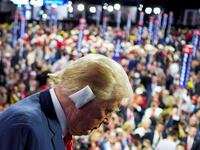 Donald Trump seen from the right showing his bandaged ear