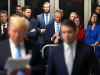 Alabama AG, Steve Marshall, second from left, Sen. J.D. Vance, R-Ohio, Eric Trump, Sen. Tommy Tuberville, R-Ala., Iowa AG Brenna Bird and Sen. Nicole Malliotakis, R-N.Y. listen listen as Donald Trump speaks ahead of court during his hush money trial.