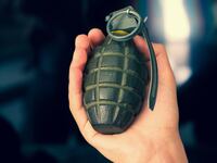 Hand grenade and black background.