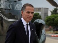 Hunter Biden, in a suit, strides by Marine One.