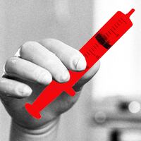 A photo illustration of a doctors hand holding a red syringe