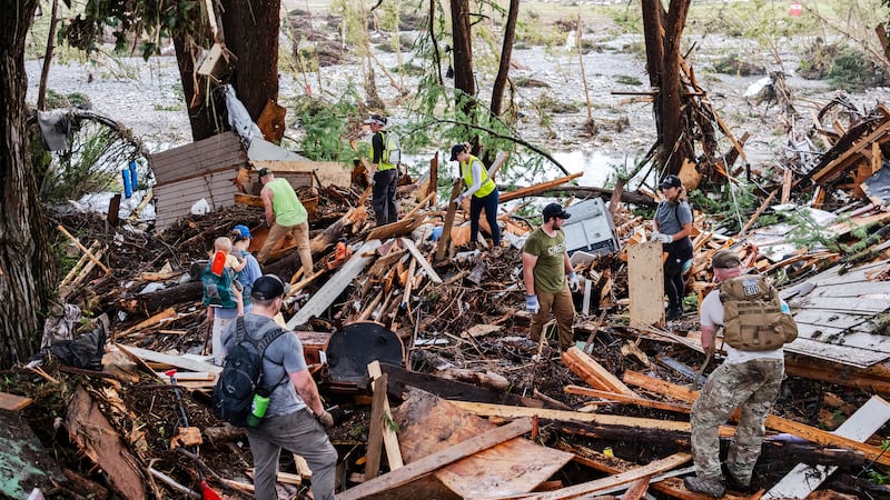 Search and rescue workers dig through debris looking for any survivors or remains of people swept up in the flash flooding on July 6, 2025 in Hunt, Texas. Heavy rainfall caused flooding along the Guadalupe River in central Texas with multiple fatalities reported.