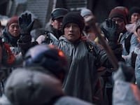 Lee Byung-hun holds his hands up in a still from Concrete Utopia