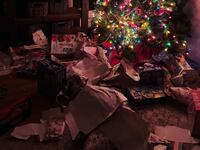 Unwrapped presents under a Christmas tree.