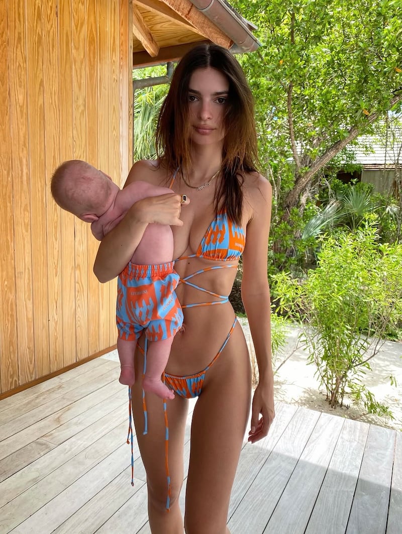 On her Instagram, Emily Ratajkowski shared pictures from the shoot holding a baby doll and a throwback photo of herself holding her son as a baby.