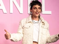 Kristen Stewart holds her thumbs up at a Chanel show