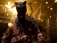 Winnie the Pooh soaked in blood in front of a fire in a still from ‘Winnie the Pooh: Blood and Honey 2’