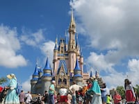 Guests walk past Cinderella Castle at the Magic Kingdom in Walt Disney World on April 2, 2025.