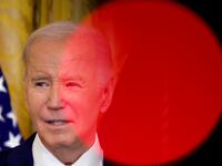 Framed by television camera lights, U.S. President Joe Biden