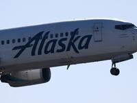 Alaska Airline plane in the air.