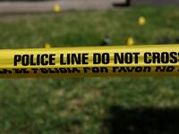 Yellow police tape placed in front of a house.