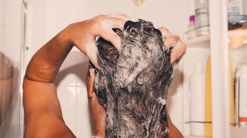 Woman washing her hair in the shower.