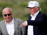 Donald Trump speaks to media mogul Rupert Murdoch as they walk out of Trump International Golf Links in Aberdeen, Scotland, June 25, 2016.