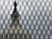 The U.S. Capitol building is seen behind security fencing