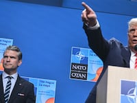US Defense Secretary Pete Hegseth (L) looks on as US President Donald Trump (R) gestures at a press conference during a North Atlantic Treaty Organization (NATO) Heads of State and Government summit in The Hague on June 25, 2025. NATO leaders hold a two-day summit on June 24 and 25 in The Hague. (Photo by Brendan SMIALOWSKI / AFP) (Photo by BRENDAN SMIALOWSKI/AFP via Getty Images)