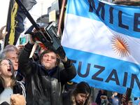 Argentine presidential candidate Javier Milei holds a chainsaw next to Carolina Piparo, candidate for governor of the province of Buenos Aires, during a campaign rally, in Buenos Aires, Argentina, Sept. 25, 2023.