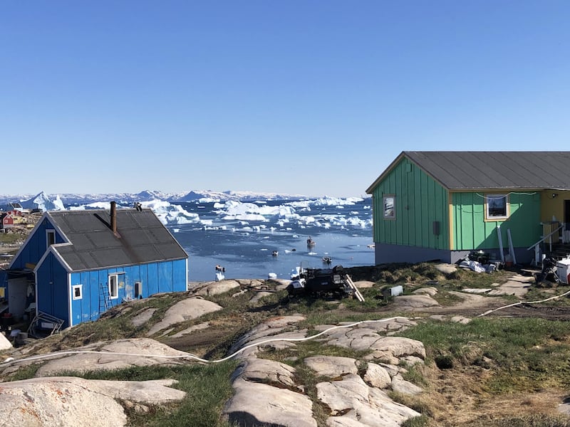 A photograph of the colorful clapboard houses in Saqqaq, Greenland.