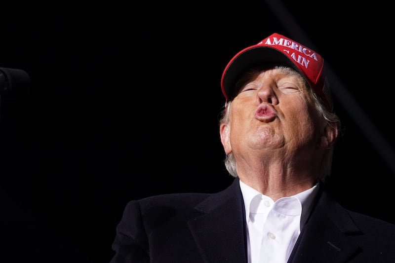Trump blowing a kiss.