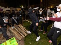 Counter protesters attack pro-Palestinian protesters at a pro-Palestinian encampment set up on the campus of the University of California Los Angeles (UCLA) as clashes erupt, in Los Angeles on May 1, 2024.