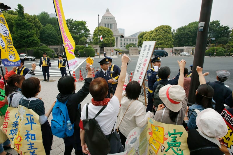 articles/2014/05/14/japanese-women-tell-their-men-they-have-to-choose-between-love-and-war/140514-adelstein-protests-japan-tease_ggod7s