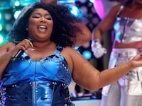 A picture of Lizzo, who has. been accused in a lawsuit filed Tuesday of creating a hostile work environment by fat shaming and sexually harassing three of her former dancers. Her ex-creative director shared support for the lawsuit.