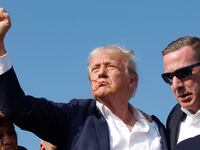Trump raises fist to the crowd after getting shot at a rally