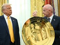 TOPSHOT - US President Donald Trump watches as FIFA president (Fédération Internationale de Football Association) Gianni Infantino presents him with the key to unlock the new FIFA Club World Cup trophy in the Oval office of the White House, in Washington, DC, on March 7, 2025. (Photo by Jim WATSON / AFP) (Photo by JIM WATSON/AFP via Getty Images)