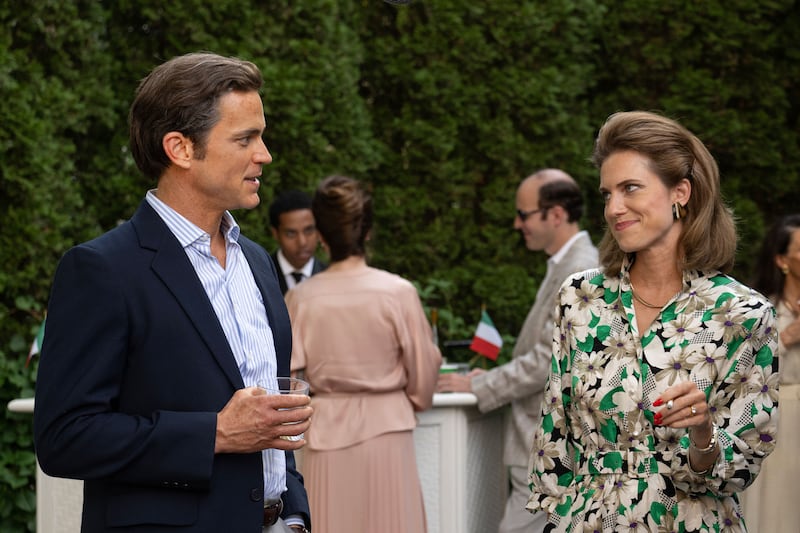 Matt Bomer and Allison Williams stand next to each other outside in a still from ‘Fellow Travelers’