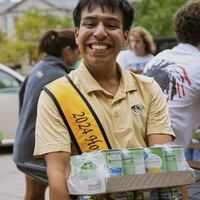 Johnathan Martinez pictured with canned goods donated to a food drive.