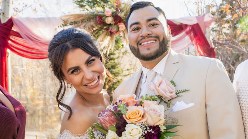 Bride and groom with best man and maid of honor posing at outdoor wedding