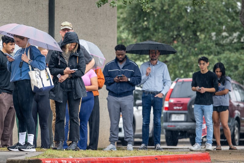 Texas voters wait in line in the rain to cast ballots on the final day of record-breaking early voting.