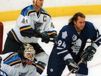 Toronto Maple Leaf forward Sergei Berezin, helmetless in front of the goal.