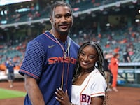 Simone Biles and Jonathan Owens pose for a picture before a game