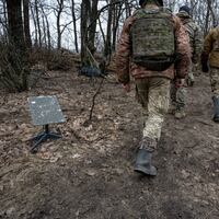 Soldiers of the Ukraine Army walk past a Starlink satellite internet receiver on February 18, 2024 in an undisclosed location, Ukraine.