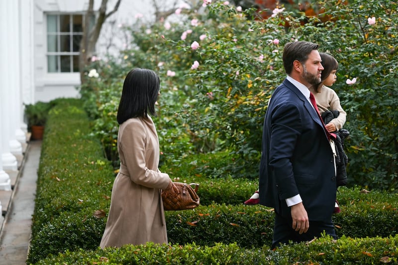 US Vice President JD Vance (R), carrying daughter Mirabel, and Second Lady Usha Vance arrive for the White House turkey pardon ceremony in the Rose Garden.
