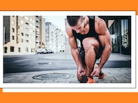 Man tying his shoes on the street.