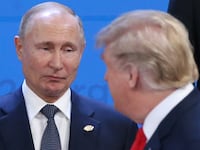 Russian President Vladimir Putin (L) looks at U.S. President Donald Trump during the welcoming ceremony prior to the G20 Summit's Plenary Meeting on November 30, 2018
