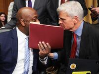 Sen. Bill Cassidy (R) (R-LA) confers with Sen. Tim Scott (C) (R-SC) after the Senate Finance Committee voted to advance the nomination of Robert F. Kennedy Jr. to be the next Secretary of Health and Human Services on February 04, 2025 in Washington, DC. The full committee voted along party lines to advance the nomination to the entire Senate for confirmation.(Photo by Win McNamee/Getty Images)