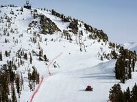 A snow-cat operator grooms an empty ski run at the popular Mammoth Mountain Ski Resort after closing time on April 16, 2024, in Mammoth Lakes, California.