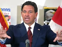 Florida Gov. Ron DeSantis answers a question after announcing a lawsuit against book publishers McGraw Hill, Inc. and Savvas Learning Co., with Florida Attorney General James Uthmeier, during a press conference at Voyager K-8 School in St. Cloud, Florida, Tuesday, Aug. 19, 2025.