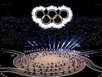 A general view as the Olympic rings come together for a fireworks display during the opening ceremony of the Milano Cortina 2026 Winter Olympics at San Siro Stadium.