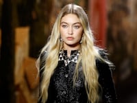 Gigi Hadid presents a creation by designer Virginie Viard as part of her Spring/Summer 2024 Women's ready-to-wear collection show
