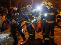 Emergency staff carry a wounded local resident at a site of an apartment building damaged during a Russian missile strike, amid Russia’s attack on Ukraine, in Kyiv, Ukraine December 13, 2023.